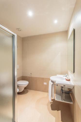 a bathroom with a sink and a toilet at Hotel Villa Ombrosa in Milano Marittima