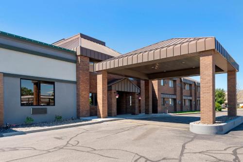 a brick building with a pavilion in a parking lot at Quality Inn St Cloud West in Saint Cloud
