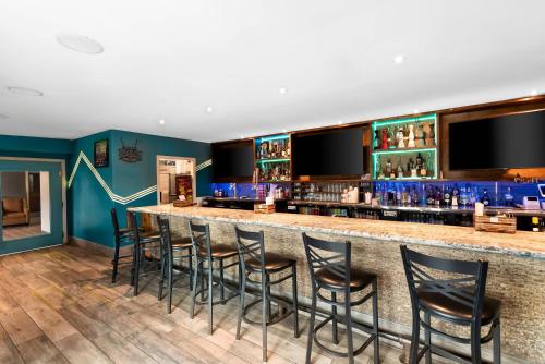 a bar with blue walls and black stools at MainStay Suites El Centro I-8 in El Centro
