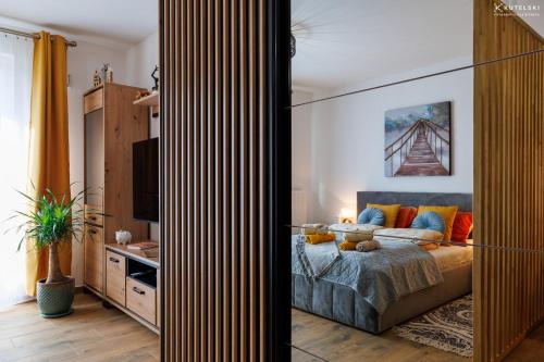 a bedroom with a bed and a tv in it at Apartament Jaśmin in Stargard
