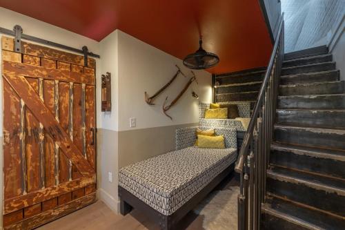 a room with a bed and a staircase with a door at Freya Geo Dome Suite At El Mistico Ranch in Nogal