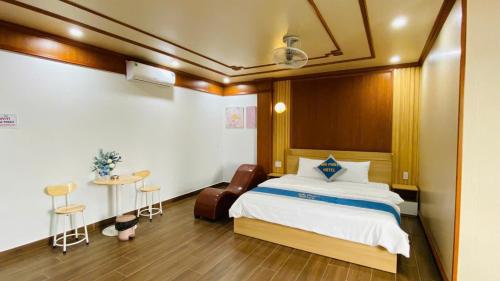 a bedroom with a large bed and a table at Hai Phat Hotel in Tam Tài