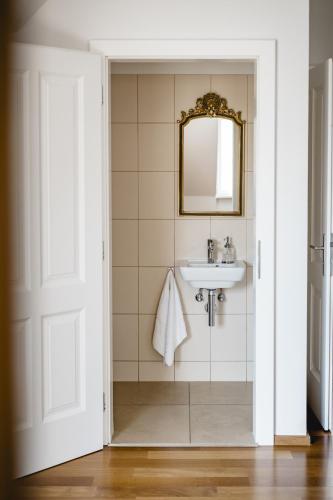 a bathroom with a sink and a mirror at My Wonderland in Salzburg
