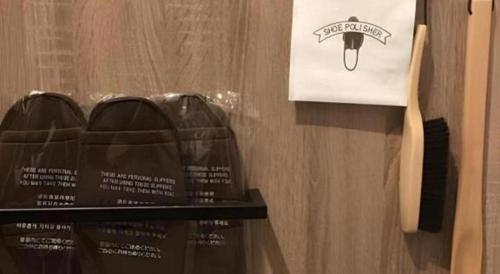 a shelf with a knife and a bag on a wall at Hotel IL FIORE Kasai in Tokyo