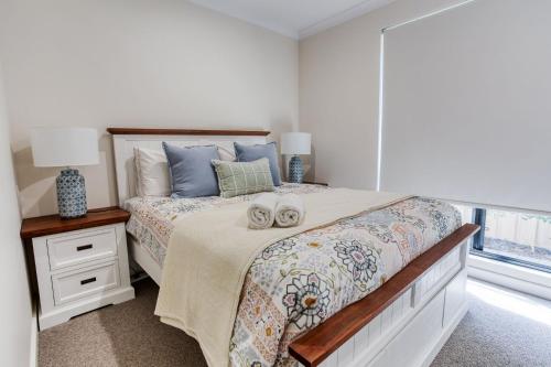 a bedroom with a bed with two towels on it at Peppermint Breeze in Vasse