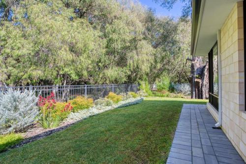 a garden with flowers and a walkway at Peppermint Breeze in Vasse