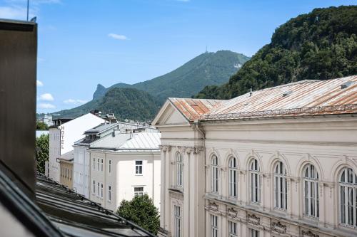 a view of a building with mountains in the background at My Wonderland in Salzburg