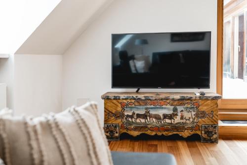 a living room with a flat screen tv on a stand at My Wonderland in Salzburg