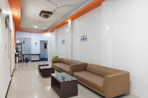 a living room with a couch and a table at TwoSpaces Living at Nabila Semampir Homestay in Semampir
