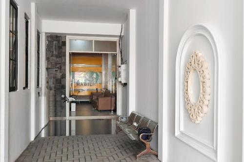 a hallway with a couch and a mirror on a wall at TwoSpaces Living at Nabila Semampir Homestay in Semampir