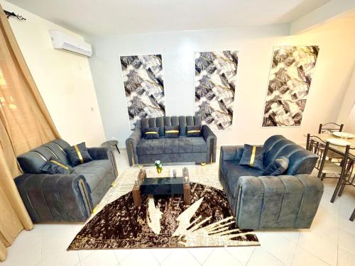 a living room with blue couches and a table at Appartement Duplex in Dakar