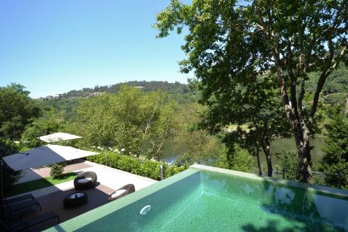 a swimming pool with a view of a mountain at Douro Green in Castelo de Paiva