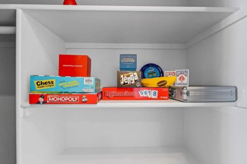 a shelf with books and other items on it at Polar Express Hot Tub Pool Table Mountain Views in Williams