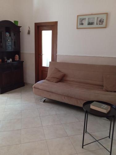 a living room with a couch and a chair at The Vesuvian House in San Giorgio a Cremano