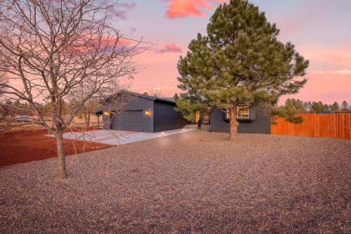 a black house with two trees in front of it at Polar Express Hot Tub Pool Table Mountain Views in Williams