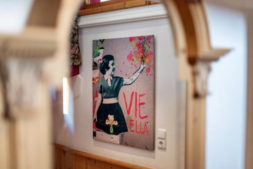a picture of a woman with flowers on a wall at Boutique Appartments Gerlosperle in Gerlos