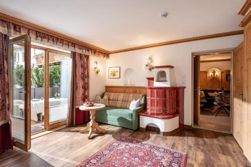 a living room with a couch and a table at Boutique Appartments Gerlosperle in Gerlos
