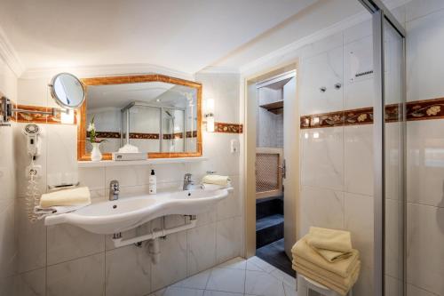 a bathroom with a sink and a shower at Boutique Appartments Gerlosperle in Gerlos