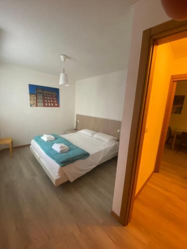 a bedroom with a bed with a blue blanket at Residence Villa Susy in Duino