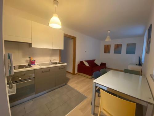 a kitchen and living room with a red couch at Residence Villa Susy in Duino