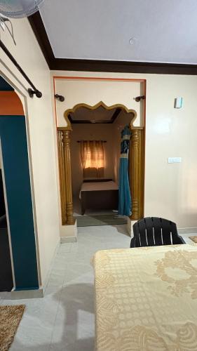 a bedroom with a bed and a fireplace in a room at Podanolana residency- Sleep Above the Clouds in Madikeri