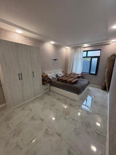a large room with a bed and a window at Quba Villa in Quba
