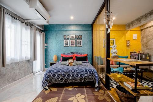 a bedroom with a bed with a teddy bear on it at Double Studio with Balcony & Private Bath by Smile Loft in Ban Na Song