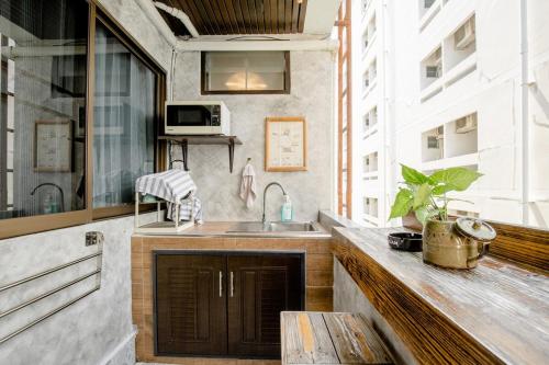 a kitchen with a sink and a counter top at Double Studio with Balcony & Private Bath by Smile Loft in Ban Na Song