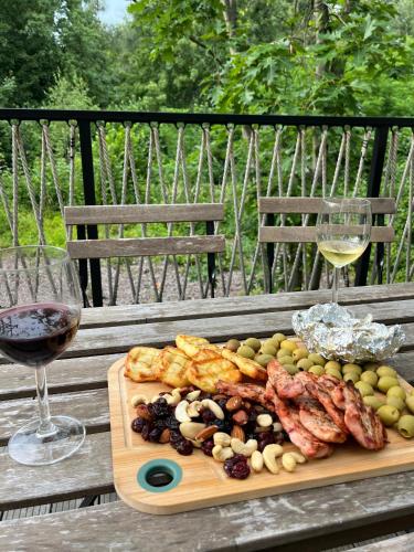 a plate of food and a glass of wine on a table at Posed U HRADU in Jaklovec