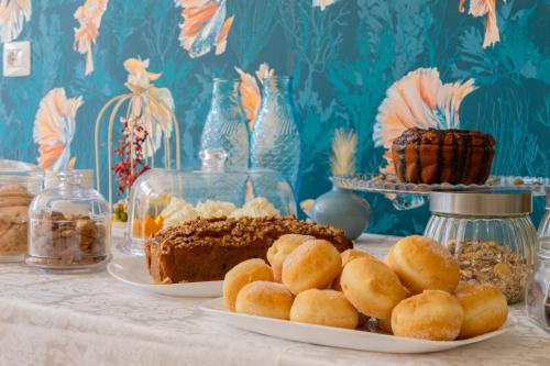 a table topped with plates of food and desserts at Aura Living Hotel in Rimini