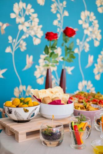 a table with plates of food and bowls of food at Aura Living Hotel in Rimini