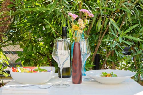a table with two bowls and a bottle of wine at Aura Living Hotel in Rimini