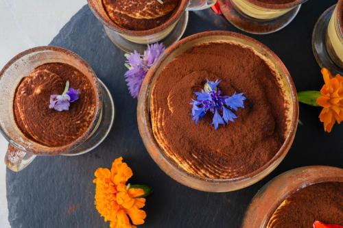 a group of bowls with flowers on a table at Aura Living Hotel in Rimini