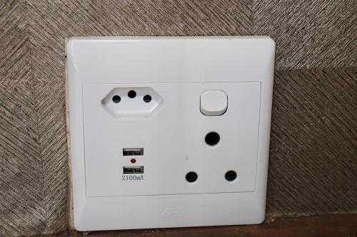 a white wii remote control sitting on a couch at Victoria Manor in Upington
