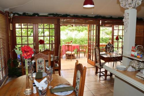 a kitchen and dining room with a table and chairs at Victoria Manor in Upington