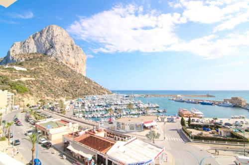 a view of a harbor with a mountain in the background at Riurau Home - Primera línea in Calpe