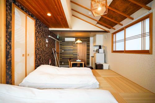 a bedroom with two beds in a room at 伏見稲荷 -菊- in Kyoto