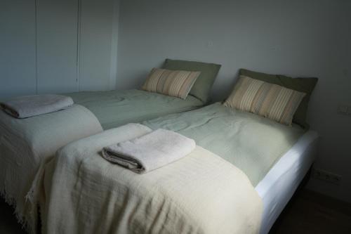 two beds sitting next to each other in a room at Cozy apartment in Grindavík in Grindavík