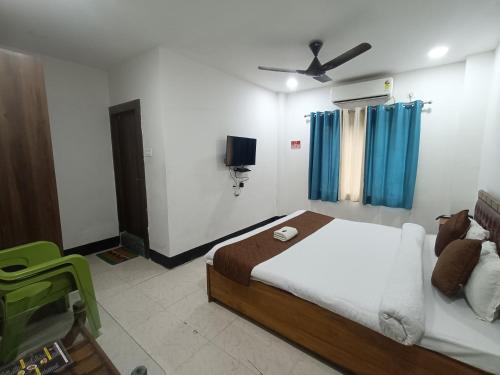 a bedroom with a bed and a ceiling fan at Hotel New Ganga in Guwahati