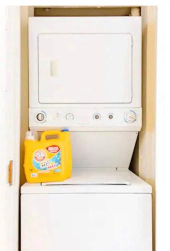 a microwave oven sitting on top of a refrigerator at Greely Gaslamp - Loft W Parking & 3 Beds #302 in San Diego