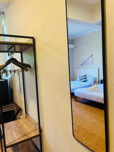 a mirror in a room with a bed and a bedroom at Rhu Dormitory in Tanjung Rhu 
