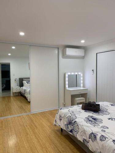 a bedroom with a bed and a mirror at 5 Swan Valley Special 3br 15 Bth in Perth