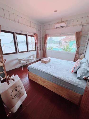 a bedroom with a bed with a bag in it at Hostel 126 Cafe' & Bar in Prachuap Khiri Khan