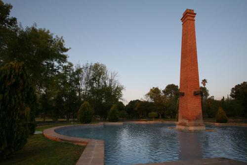 a tower in the middle of a pond in a park at Hacienda Jurica by Brisas in Querétaro