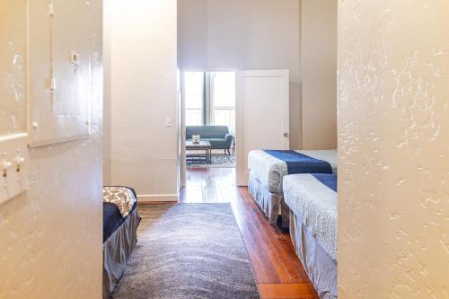a room with two beds and a living room at Greely Gaslamp - Loft W Parking & 4 Beds #301 in San Diego