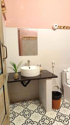 a bathroom with a sink and a toilet at Maidi Homestay Mui Ne in Mui Ne