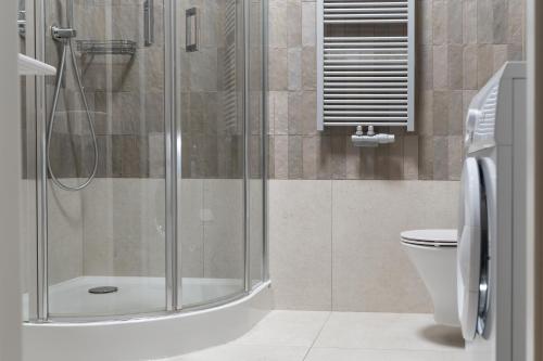 a bathroom with a shower and a toilet at Browar Hevelius Apartments by Grand Apartments in Gdańsk