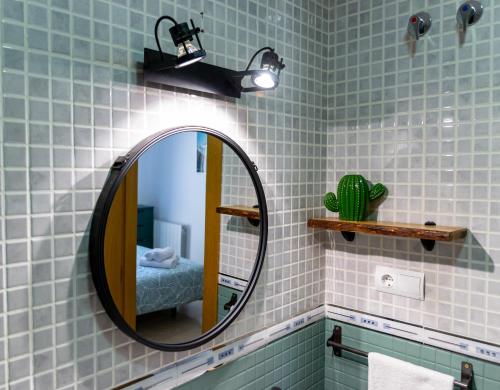 a bathroom with a mirror and a bed in a room at Apartamento amplio con gran terraza y vistas in Monachil