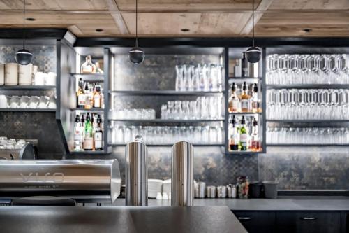 a bar with many glasses on the wall at Hotel Grauer Bär in Sölden