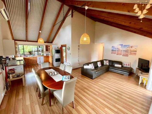 a large living room with a table and a couch at The Tree House Dunsborough in Dunsborough